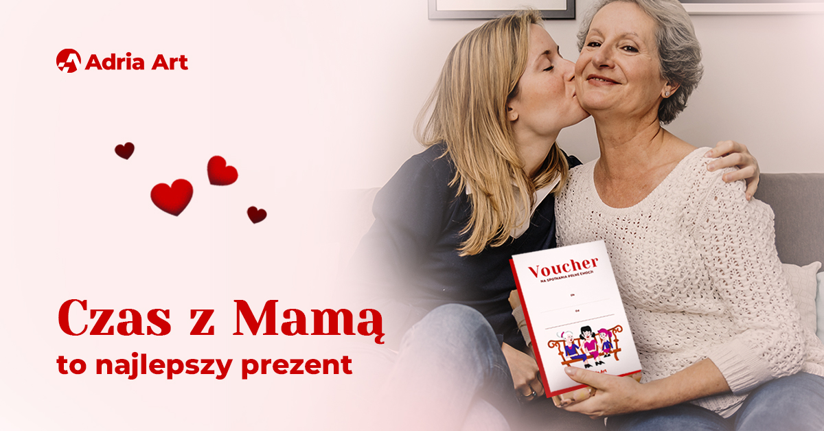 Young woman kissing older woman on the cheek while they hold a voucher; 'Czas z Mamą' gift ad with Adria Art logo