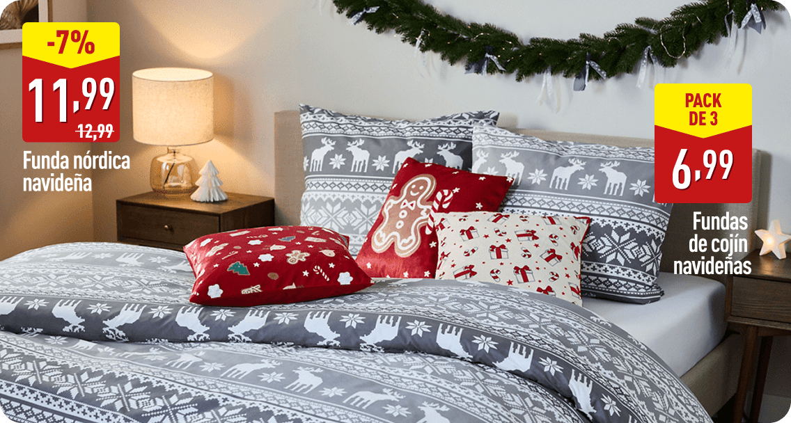 Cama decorada con funda nórdica gris de motivos navideños en blanco y varios cojines con estampados festivos en rojo y beige. A la izquierda aparece el texto -7 %, 11,99 € antes 12,99 €, Funda nórdica navideña. A la derecha, Pack de 3, 6,99 €, Fundas de cojín navideñas.