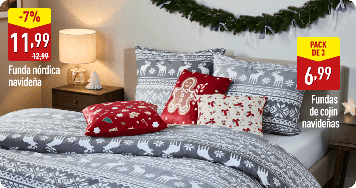 Cama decorada con funda nórdica gris de motivos navideños en blanco y varios cojines con estampados festivos en rojo y beige. A la izquierda aparece el texto -7 %, 11,99 € antes 12,99 €, Funda nórdica navideña. A la derecha, Pack de 3, 6,99 €, Fundas de cojín navideñas.