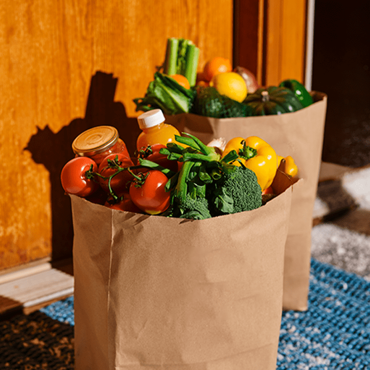 Two grocery bags filled with produce