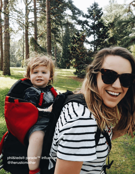 Mother and baby using phil&teds parade carrier