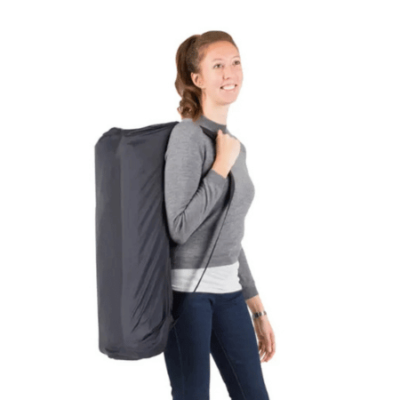 Woman holding a packed traveller