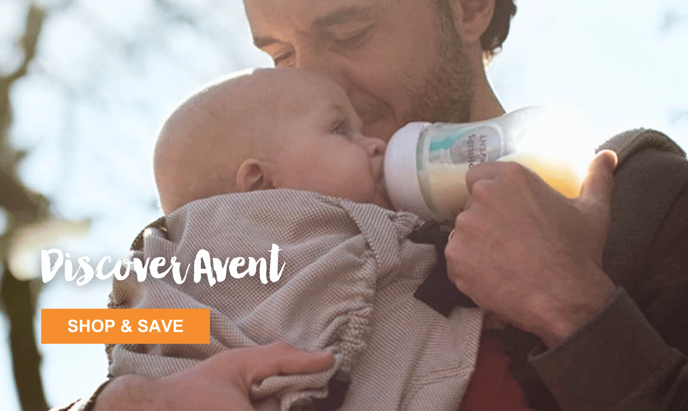 Father wearing baby in front carry pack. Feeding Child bottle