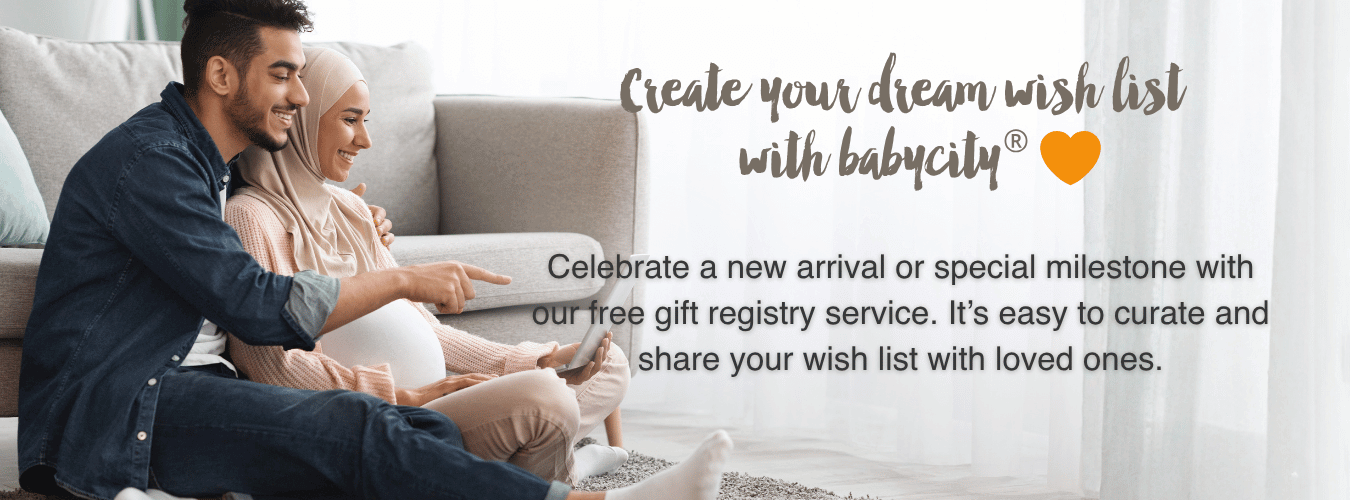 Mother and Father to be looking at laptop. Create your dream registry