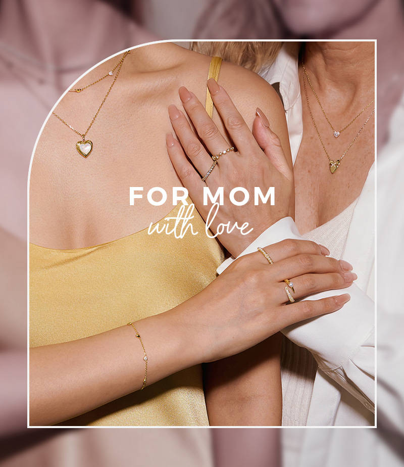 Mom and Daughter wearing matching gold jewelry.