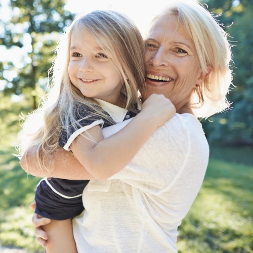 Woman smiling holding a young girl