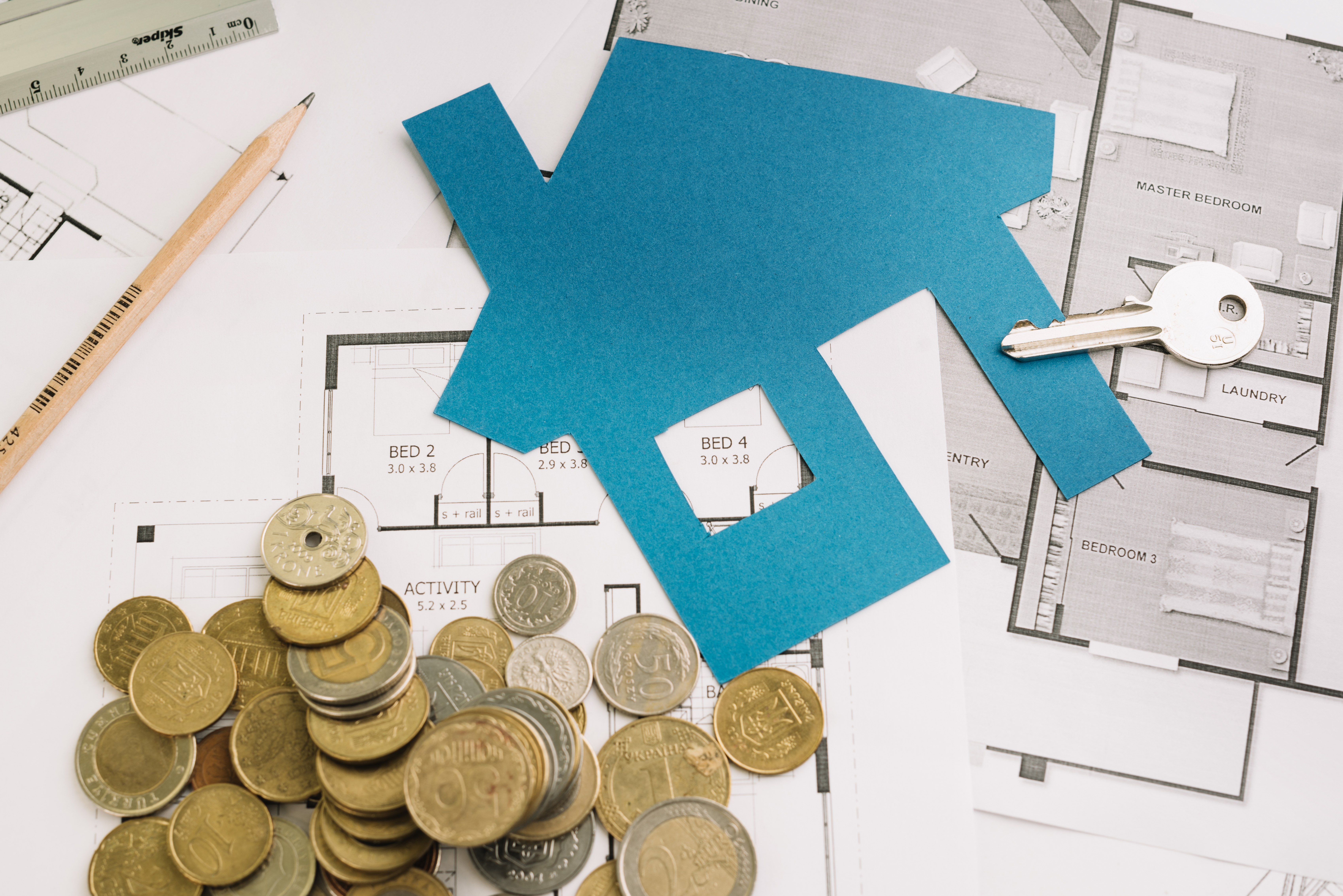 key-with-house-figurine-coins