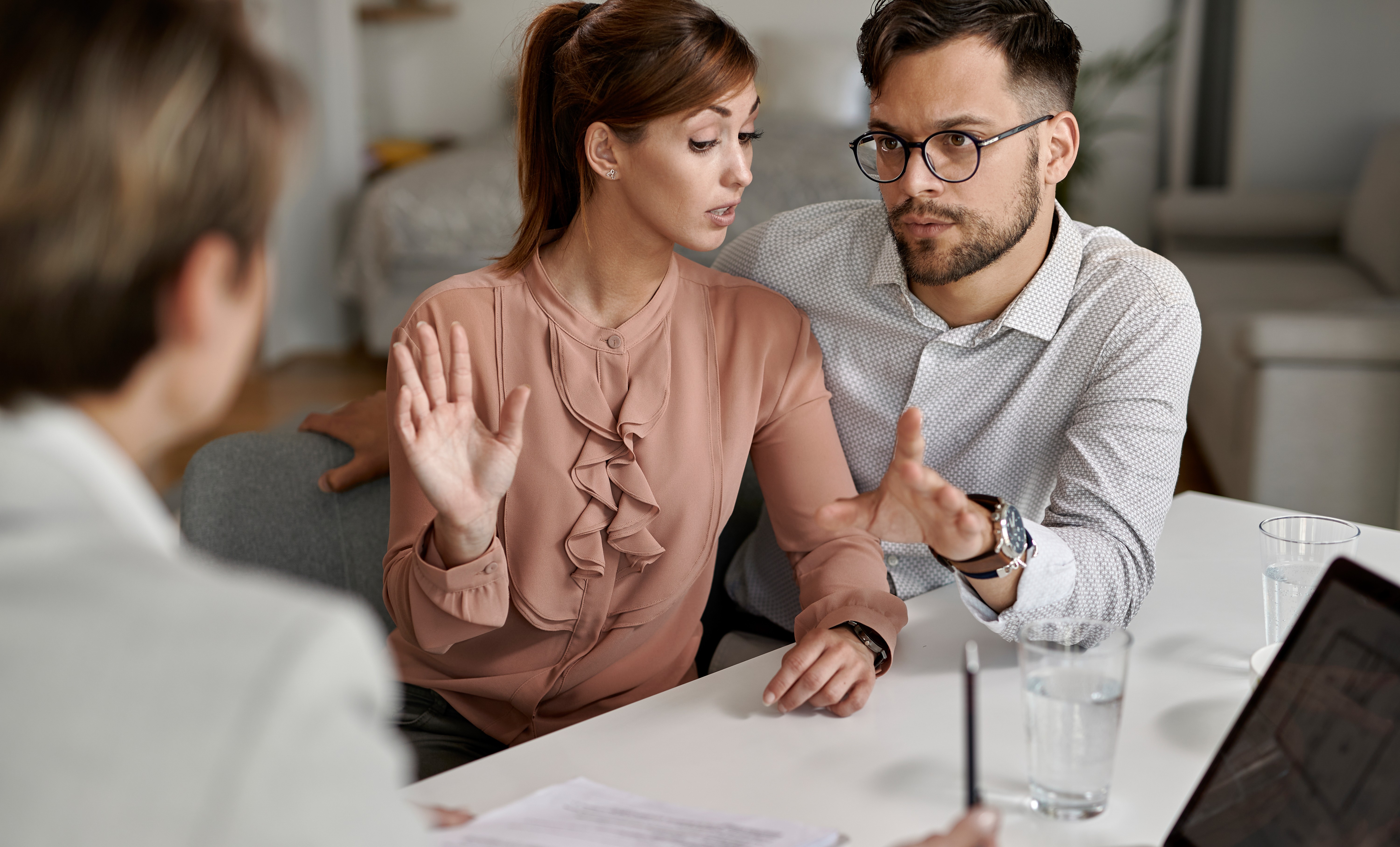 young-couple-communicating-with-insurance-agent-meeting