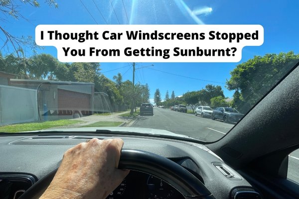 Hand with sun spots on steering wheel in the sun