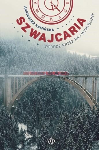 Red panoramic train crossing an arched viaduct above a snow-covered Swiss forest in winter, atmospheric mountainous landscape