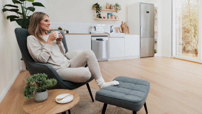Woman in loungewear sits in a chair Total care IMG5