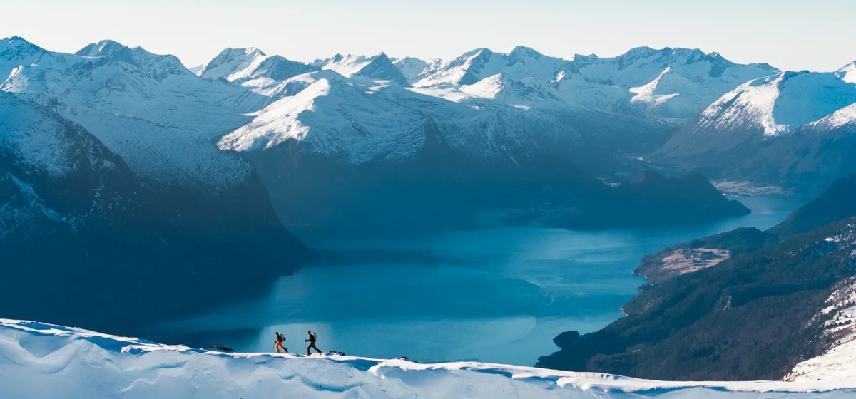 Snowy alpine ridgeline and mountain lake representing Rab Microlight Alpine warmth for New Zealand winter conditions
