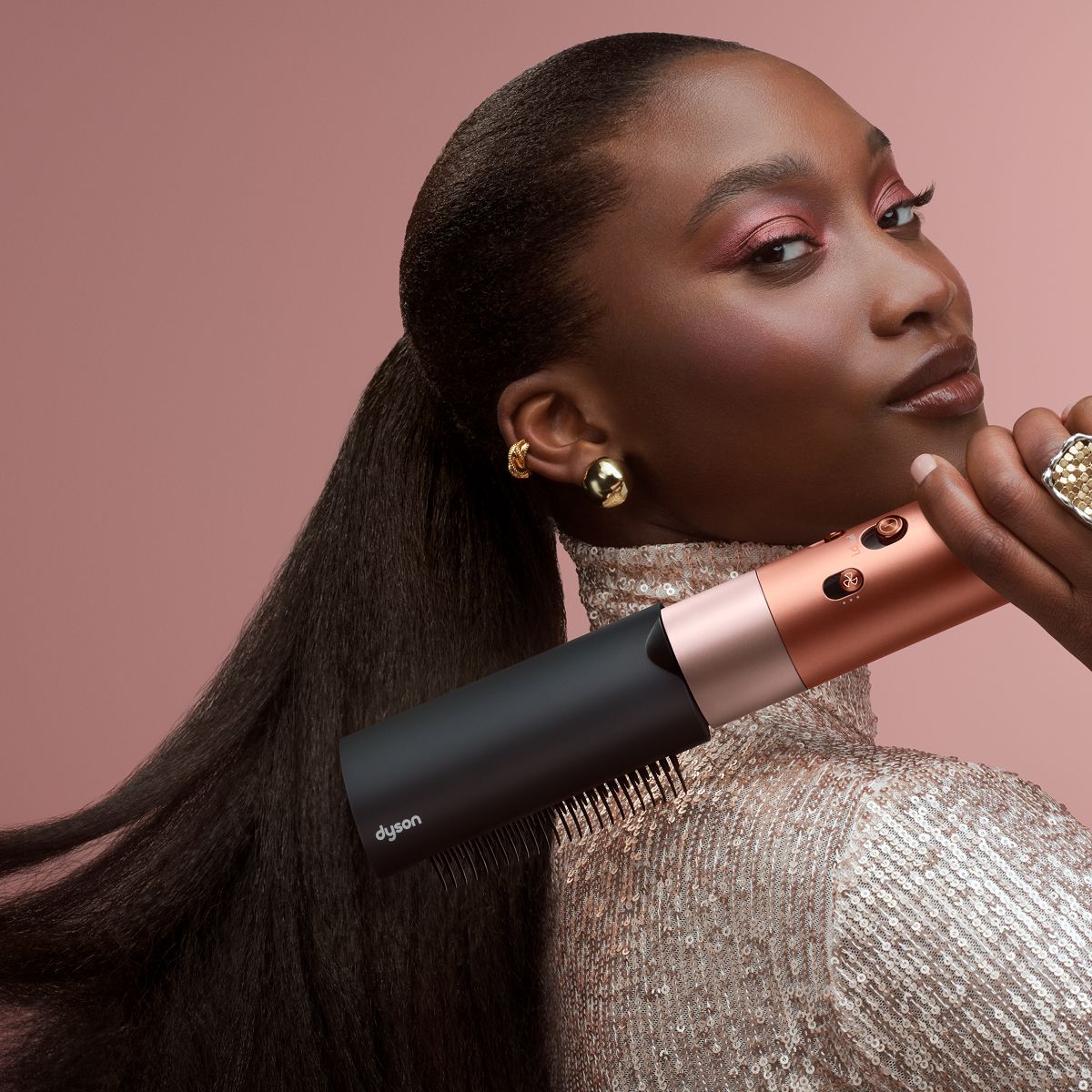 A model brushes her hair with the Dyson Airwrap ID multi-styler and dryer.