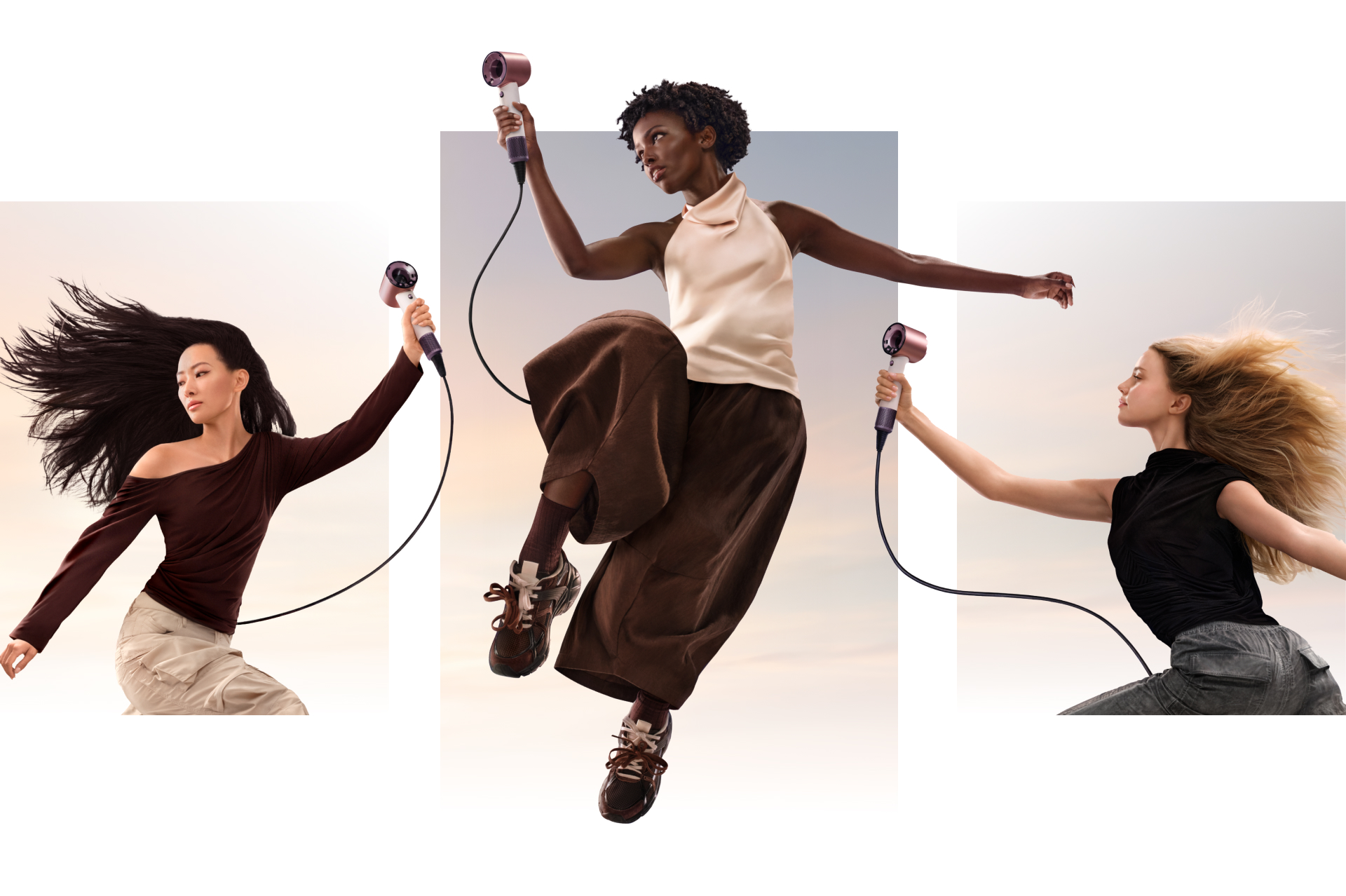 Een groep modellen dat in de lucht springt en de Dyson Supersonic Travel föhn vasthoudt.