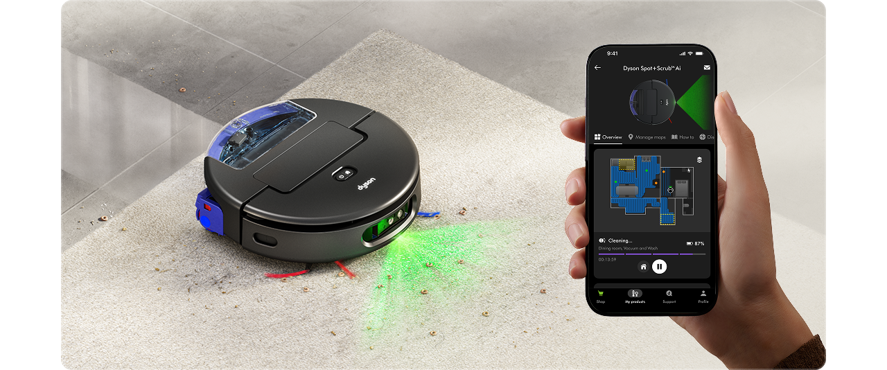 Dyson Spot+Scrub Ai robot vacuum next to a phone showing the MyDyson app.