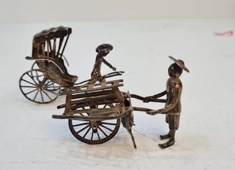 Wang Hing; Two silver figures by Wang Hing, Hong Kong late 19th, early 20th Century. One figure pulling a cart and one pushing a cart