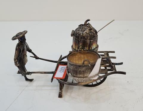 A Chinese silver novelty salt by Hung Chong, of a figure pushing a cart