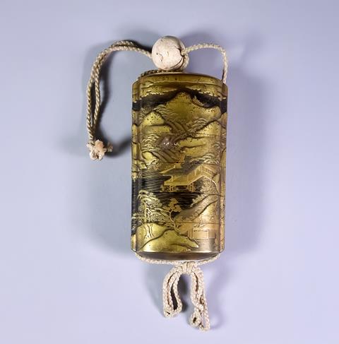 A Japanese Gilt Lacquer Five-Case Inro, 19th Century, of oval section, with raised decoration in various tones of gilt with a continuous river landscape, with pagoda, bridges, trees and mountains, 3.75ins (9.5cm) high, with bead