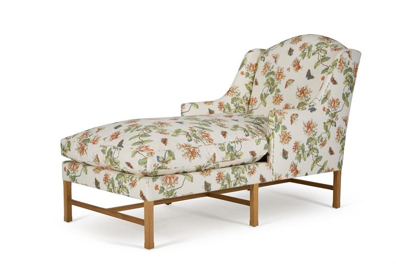 A DAYBED UPHOLSTERED IN 'HONEYSUCKLE YELLOW' FABRIC BY COLEFAX AND FOWER