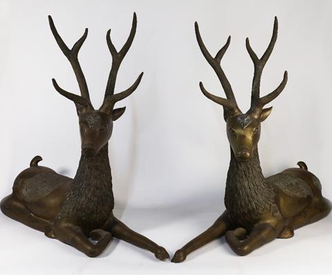 A pair of large hollow brass sculptures of recumbent Indian deer, 20th century