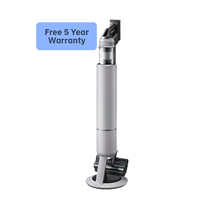 Elderly couple dancing and laughing indoors.