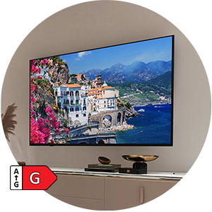 Wall-mounted TV displaying coastal village scene.