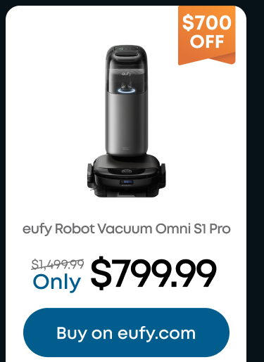 Woman wearing an olive green blazer and light blue jeans walking in an urban setting.