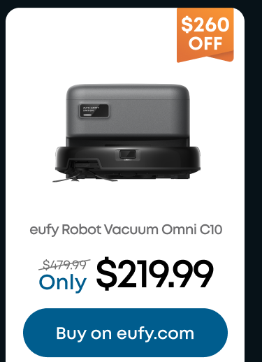 Woman wearing an olive green blazer and light blue jeans walking in an urban setting.