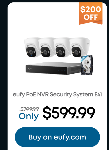 Man in a gray blazer over a dark gray shirt standing on stairs in an urban background.