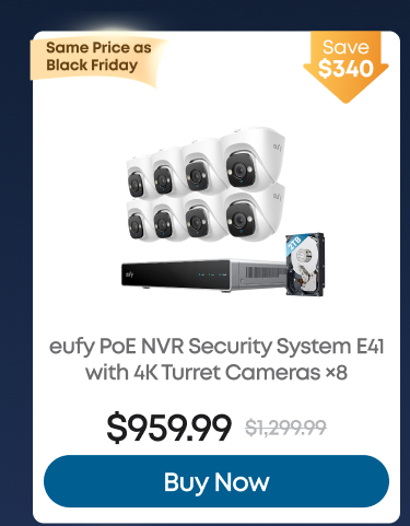 Man in a gray blazer over a dark gray shirt standing on stairs in an urban background.