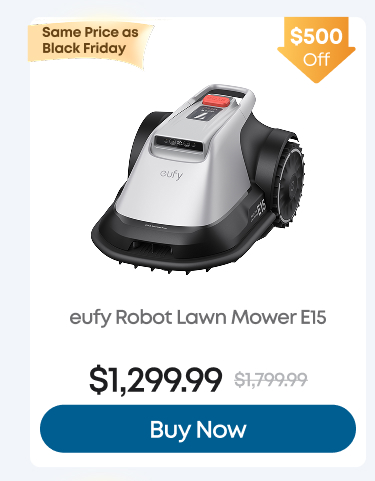 Man in a gray blazer over a dark gray shirt standing on stairs in an urban background.