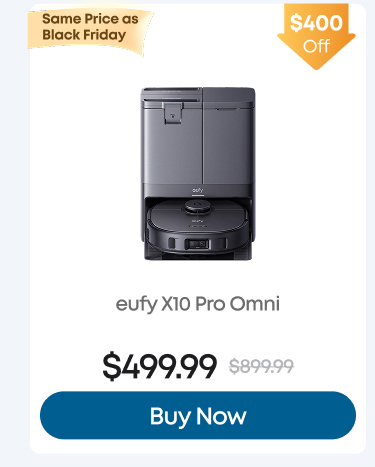 Man in a gray blazer over a dark gray shirt standing on stairs in an urban background.