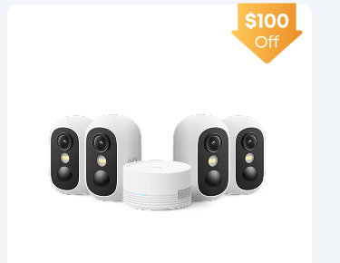 Woman wearing an olive green blazer and light blue jeans walking in an urban setting.