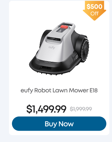 Man in a gray blazer over a dark gray shirt standing on stairs in an urban background.