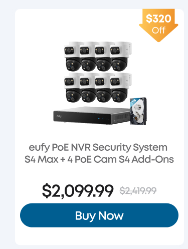 Man in a gray blazer over a dark gray shirt standing on stairs in an urban background.