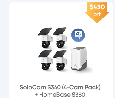 Man in a gray blazer over a dark gray shirt standing on stairs in an urban background.