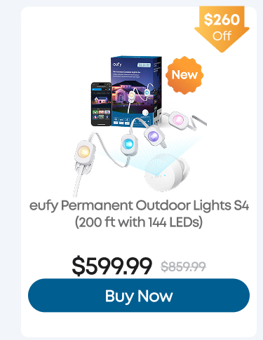 Man in a gray blazer over a dark gray shirt standing on stairs in an urban background.