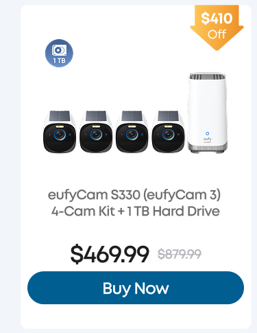 Man in a gray blazer over a dark gray shirt standing on stairs in an urban background.