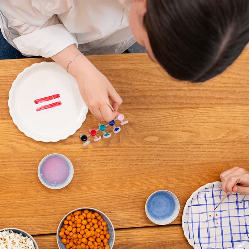 People painting the DIY Celebration plate