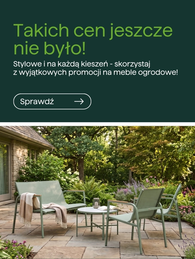 Outdoor patio with pale green metal garden chairs and table on stone paving, cosy throws and lush planted borders