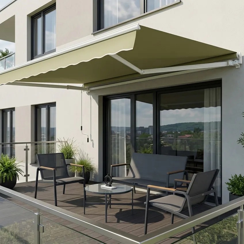Modern apartment balcony with glass railing, grey outdoor seating, round coffee table, potted plants and green retractable awning