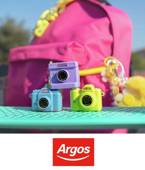Argos - Stack of toy cameras beside backpack