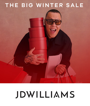 JD Williams - Man joyfully holding red gift boxes and shopping bags, wearing sunglasses. Text above reads "The Big Winter Sale"