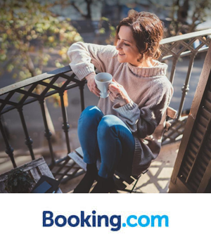 Booking.com: A woman in a cosy sweater sips coffee on a sunny balcony