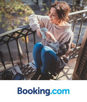 Booking.com: Woman sat on a balcony enjoying a coffee