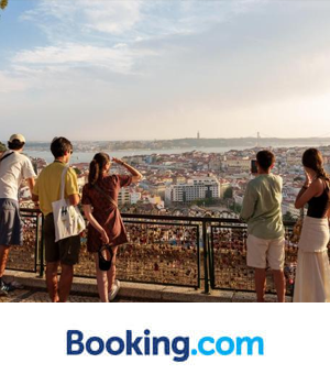 Booking.com: Couples look at view of Lisbon from balcony