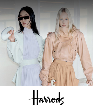 Harrods: Two models in stylish outfits pose confidently. One wears futuristic sunglasses and a light outfit; the other, in peach tones