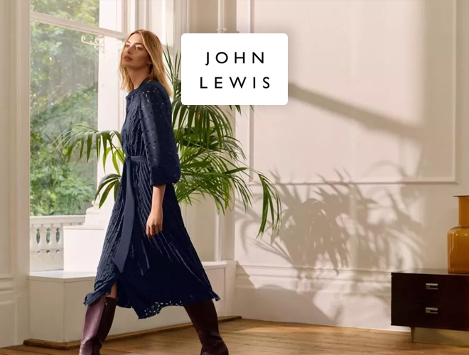 John Lewis: Woman walking through room in navy spring dress