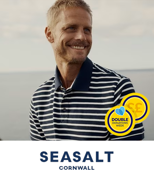 Seasalt - Man wearing striped polo shirt in coastal setting