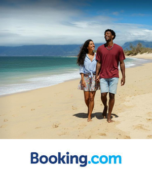 Booking.com - Couple walk across the beach
